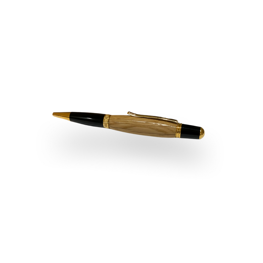 The Barrel Pen is a handcrafted executive pen with a gold and black finish, featuring a genuine oak whiskey barrel body, displayed on a white background.