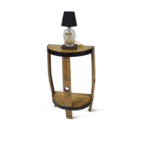 The Lamp Side Table exudes rustic charm, crafted from reclaimed whiskey barrels with a wooden half-barrel design. It features a lamp with a clear bottle base and a chic black shade.