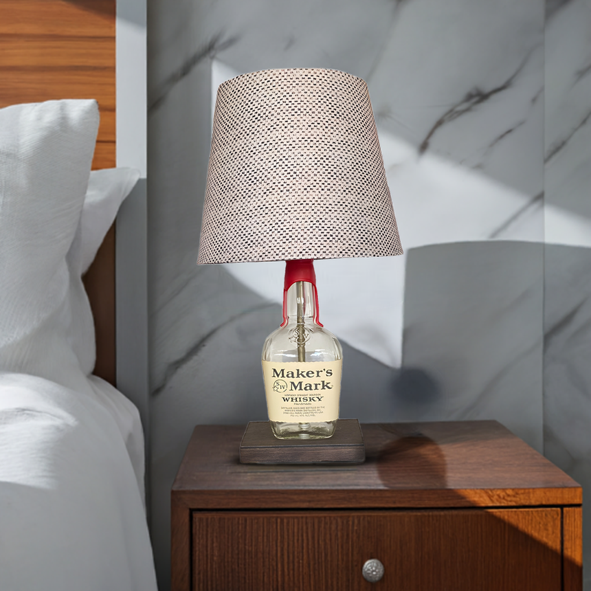 The Maker's Mark Lamp, made from an original Maker's Mark bourbon bottle, brings a distinctive accent to your home when displayed on a wooden nightstand by your bed.