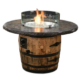 The Outdoor Firepit features a barrel design with a stone top and glass protection, elegantly emitting a warm flame.