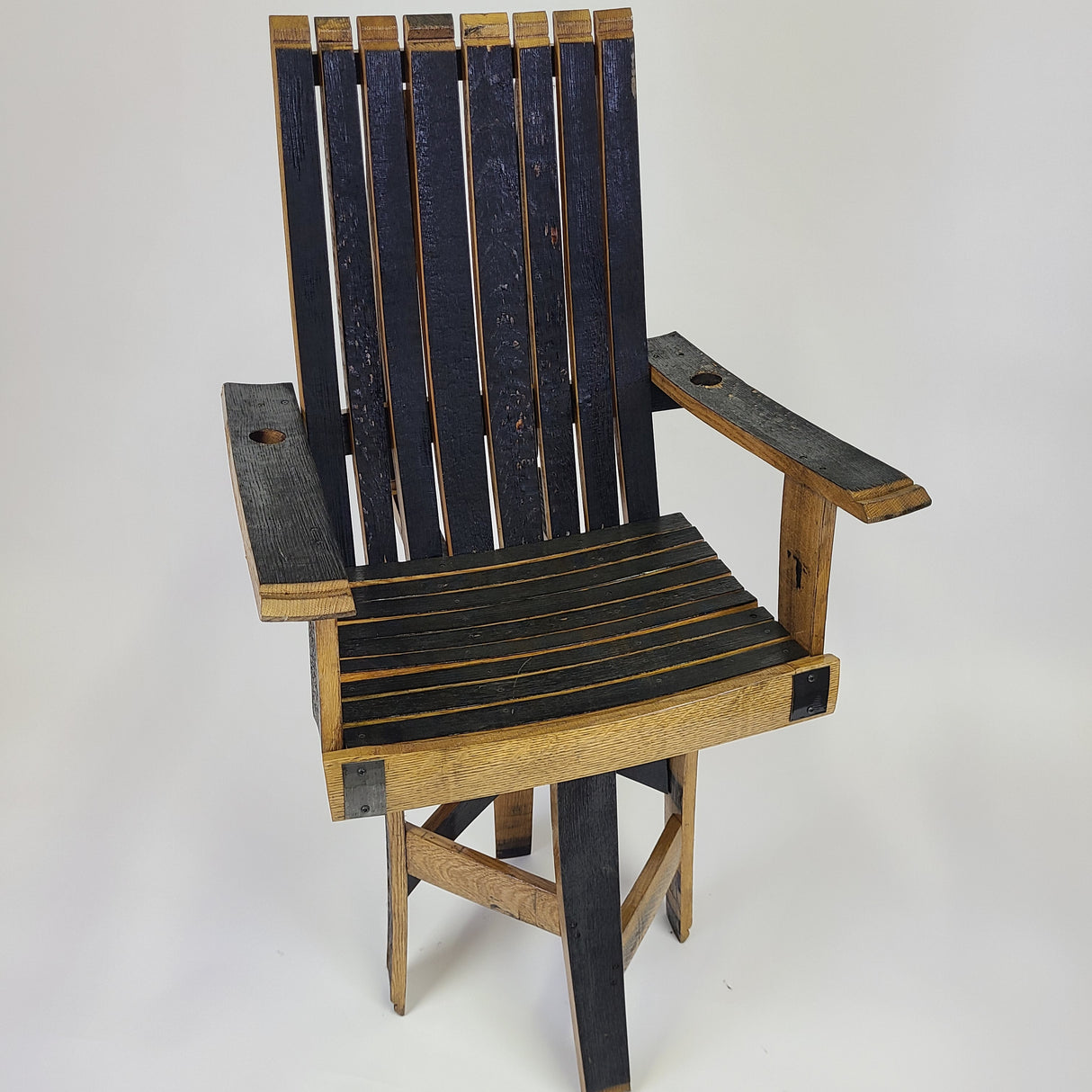 The Stave Stool Swivel with Arm Rests (model S004), priced at $225.00, is an eco-friendly wooden chair crafted from reclaimed barrel staves. It features black slats and built-in cup holders on the armrests, all set against a white background.