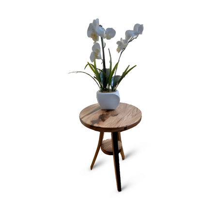 The Stave Whiskey Barrel Plant Stand, with its sturdy wooden construction and rustic charm, supports a vase holding a white orchid plant.