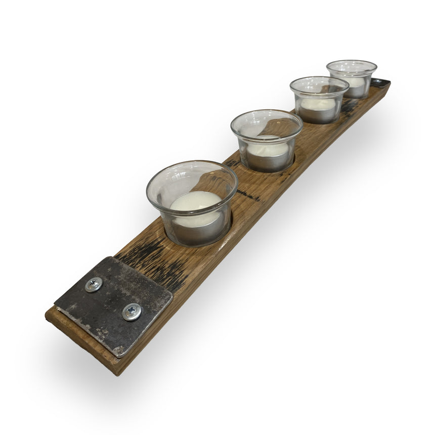 The Whiskey Barrel Stave Candle Holder features four glass votive holders in a row, bringing handcrafted rustic elegance to any setting.