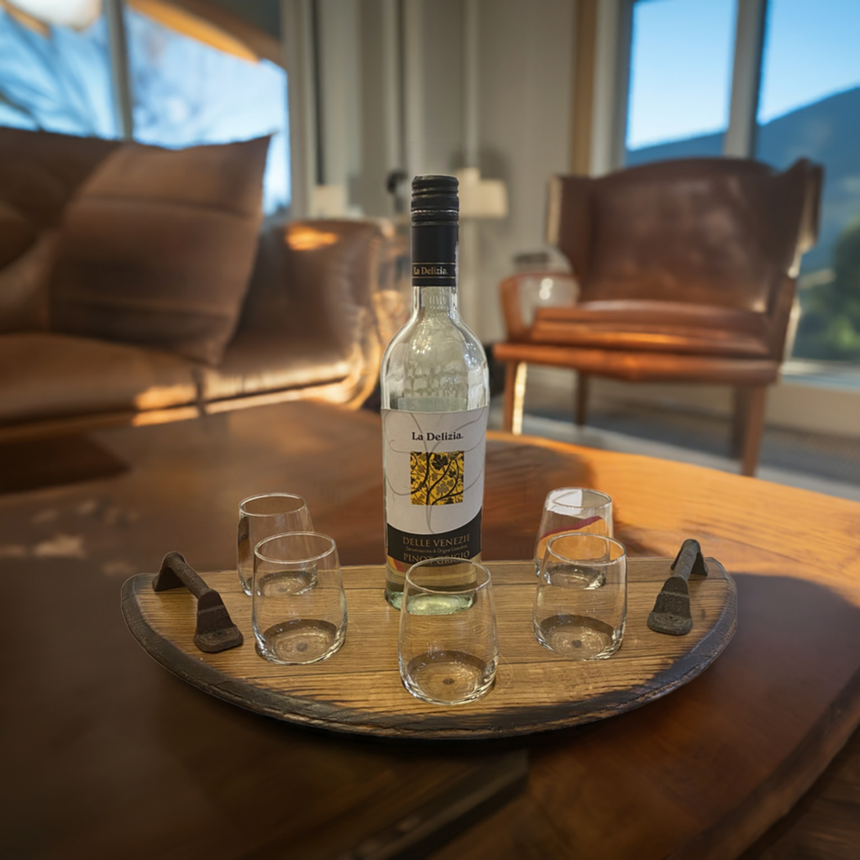 The Wine Tasting Tray, paired with a bottle of white wine and four glasses, brings rustic elegance to a cozy, sunlit living room.