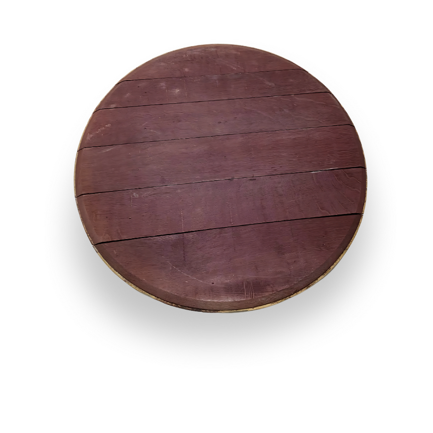 The Wine Barrel Head Charcuterie is a round wooden board with visible planks and a reddish-brown finish, evoking artisan craftsmanship inspired by classic wine barrels, shown from a top-down view.