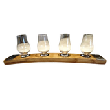 Four whiskey glasses rest empty and evenly spaced on the Whiskey Tasting Flight Board for 4 Glasses, crafted from hand-made solid wood.