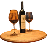 A Lazy Susan Round Swivel Tray, made from hand-crafted solid wood barrel head, elegantly displays a wine bottle and two filled glasses with a food-safe finish.