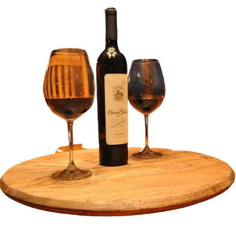 A Lazy Susan Round Swivel Tray, made from hand-crafted solid wood barrel head, elegantly displays a wine bottle and two filled glasses with a food-safe finish.