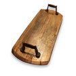 The Charcuterie and Cheese Rectangle Wooden Serving Board, crafted from solid wood with two metal handles, exudes rustic charm on a white background.